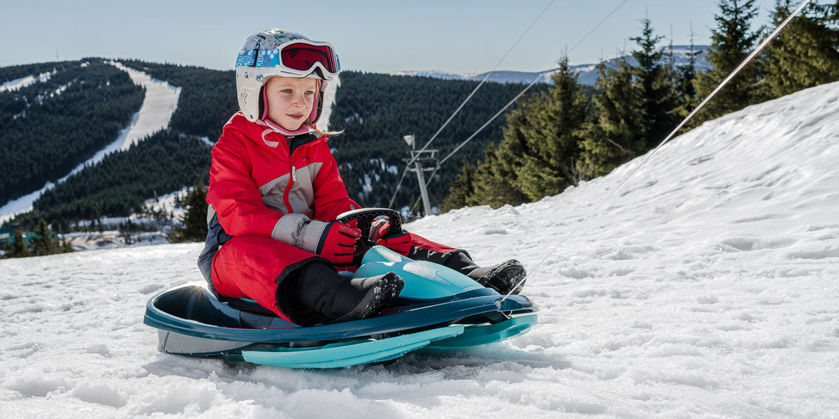 child on a sledge in Switzerland