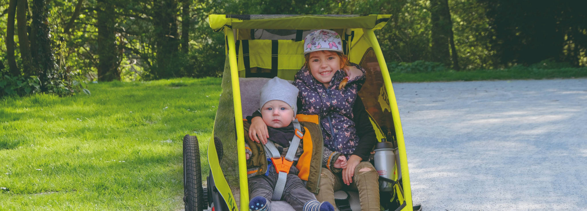 zwei kleine Kinder in einem Veloanhänger von TAXXI